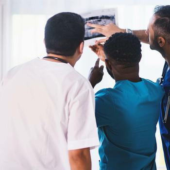 Three-person-looking-at-x-ray-result-1170979